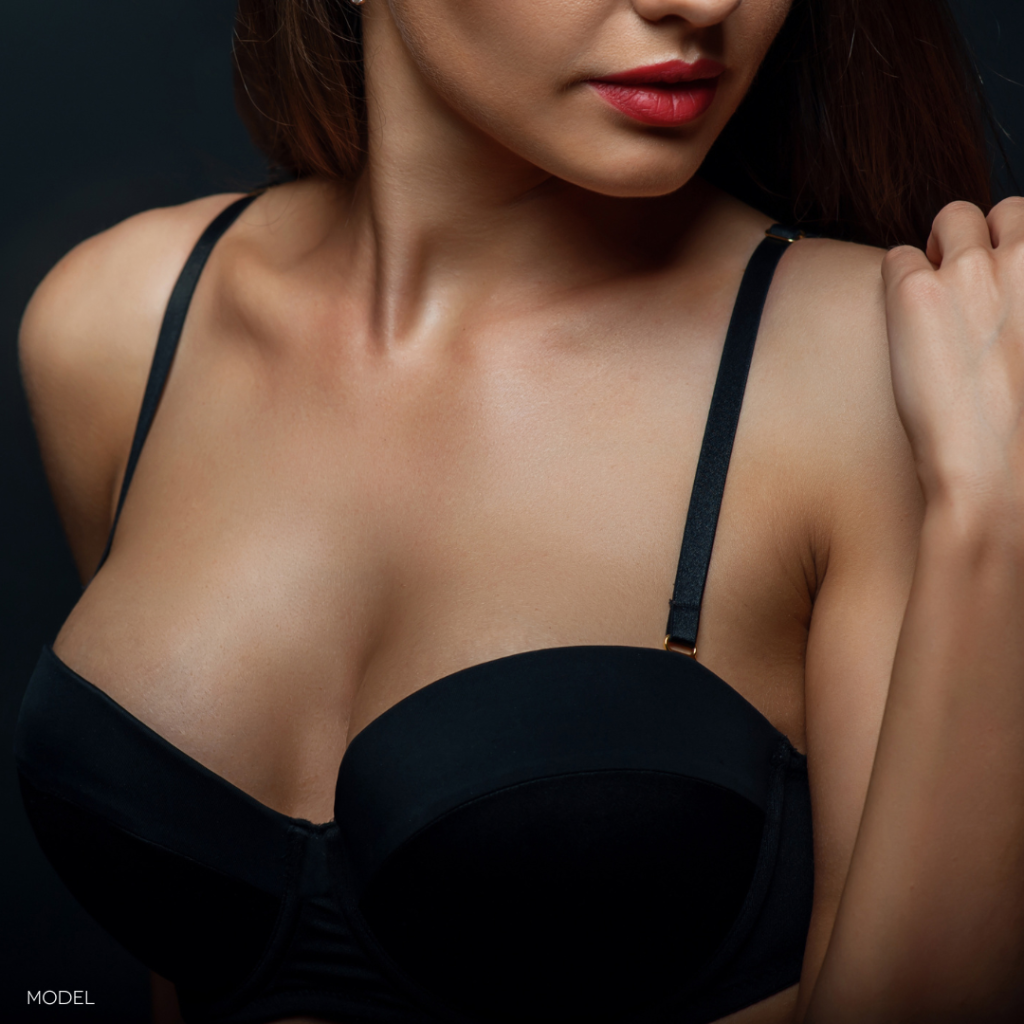 close up of woman wearing black bra