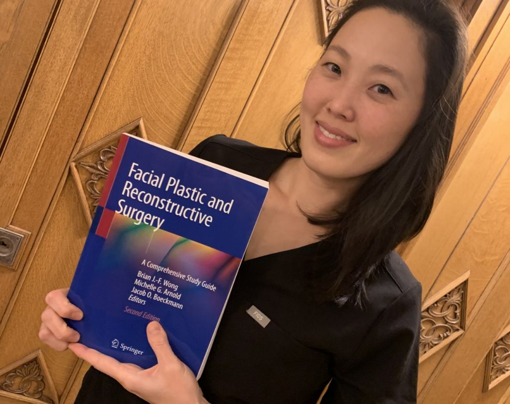 Dr. Lee with the Facial Plastic and Reconstructive Surgery guide that includes one of her published articles.